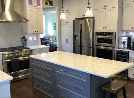 kitchen make over with a dark wood island and white grey countertop