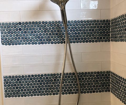 up close design of black and white tile in a tub shower as part of a rockville maryland bathroom makeover