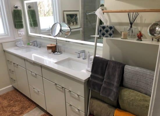 towel rack next to large double sink vanity installed as part of a bathroom remodel in rockville maryland for new homeowners