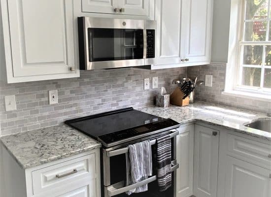 a new microwave, stove top, and countertops for a kitchen remodel