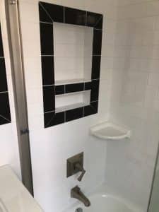 modern shower installation white tile black accents