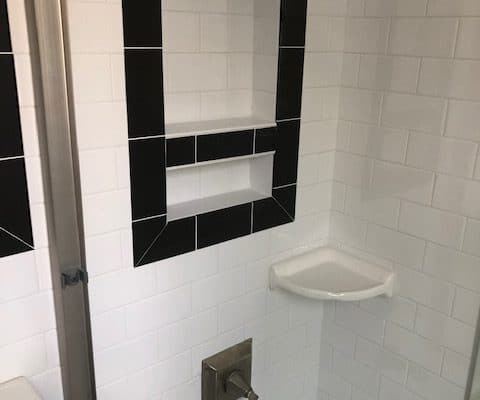 modern shower installation white tile black accents